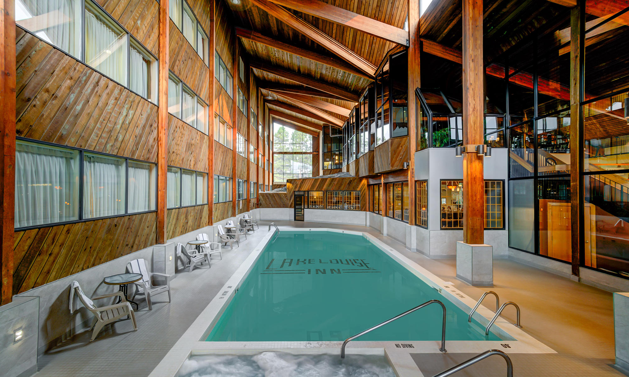 Interior Lake Louise Inn pool surrounded by high ceilings and wooden beams