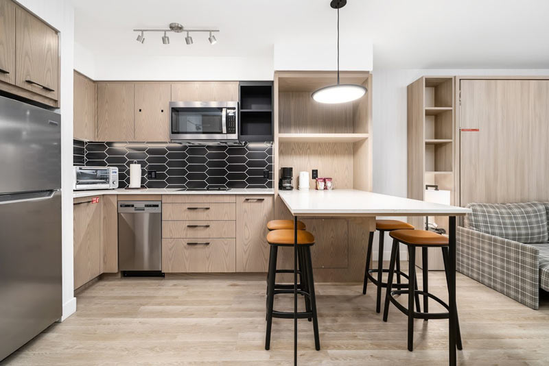 Kitchen with stove top, fridge, dishwasher, microwave and toaster