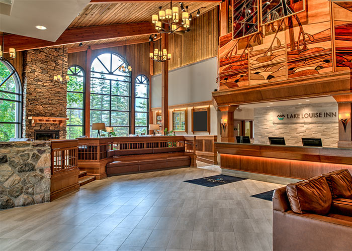 Reception area with sitting area in lobby, large windows bring in natural light