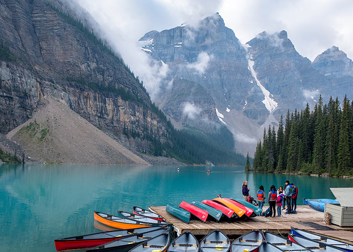 Collection of canoes on does for rent at Moraine Lake