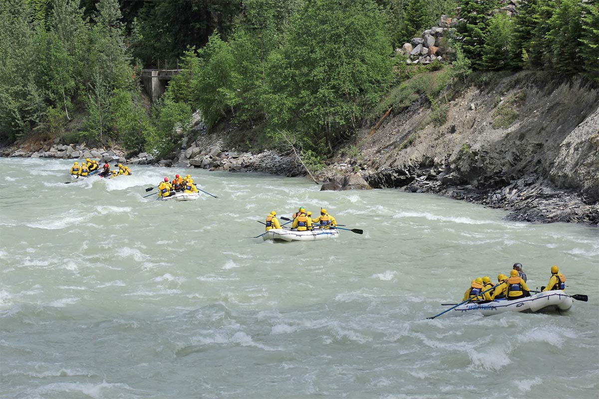 4 full rafts of people enjoying a ride down the Kicking Horse River