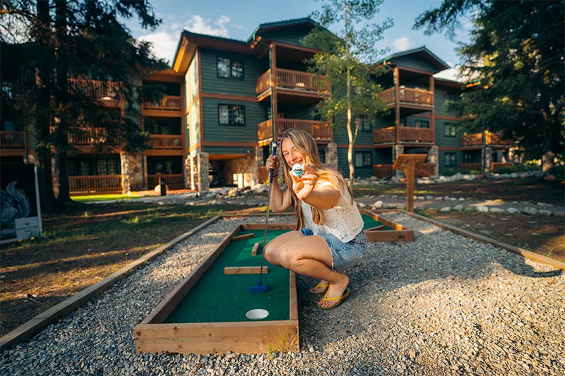 Woman playing mini golf at Lake Louise Inn