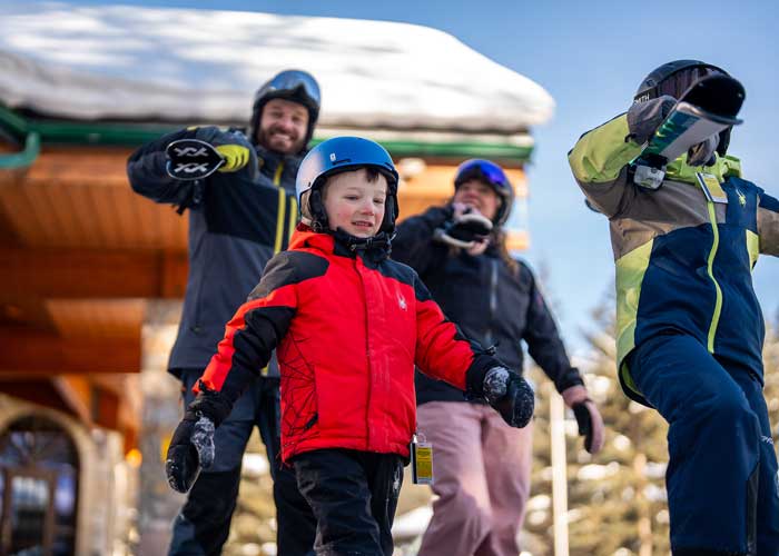 family with ski gear leaving hotel