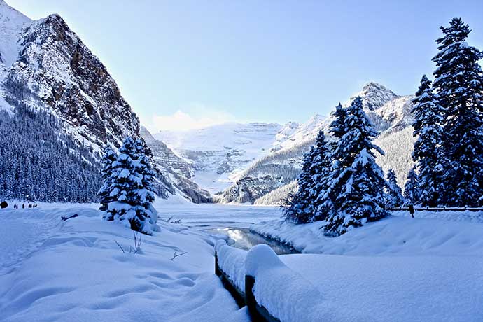 Frozen lake and snow covered mountains in Lake Louise, Alberta, Canada