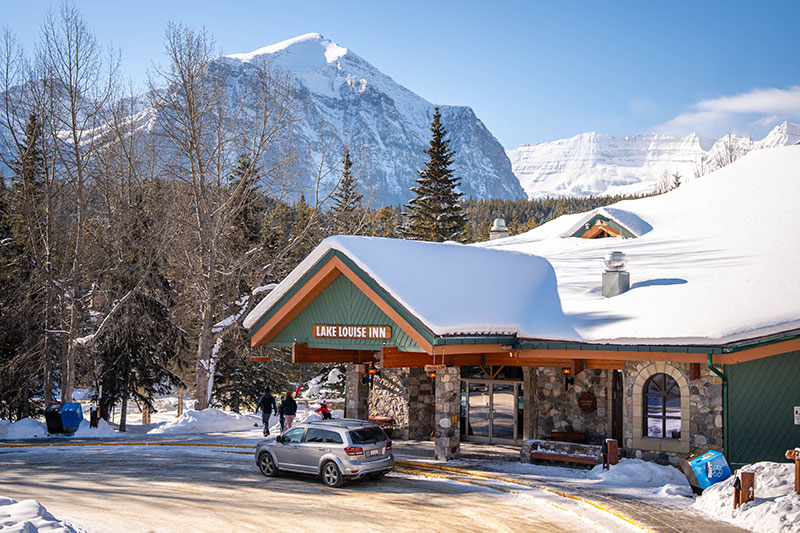 Exterior view of Lake Louise Inn covered in snow