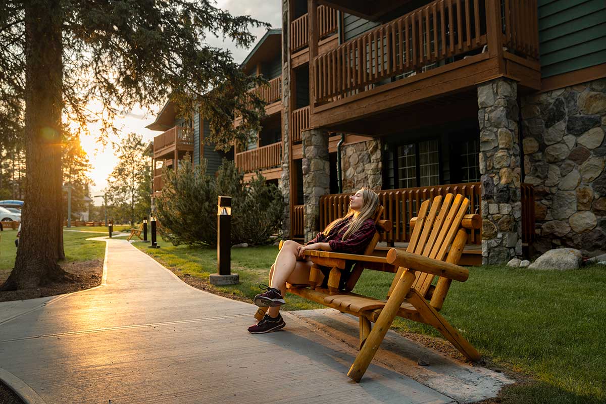 Woman seating down outside at Lake Louise Inn