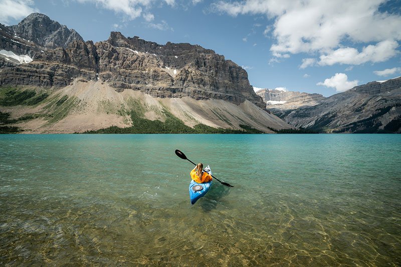 Kayaker on Lake Louise with the mountains in the back
