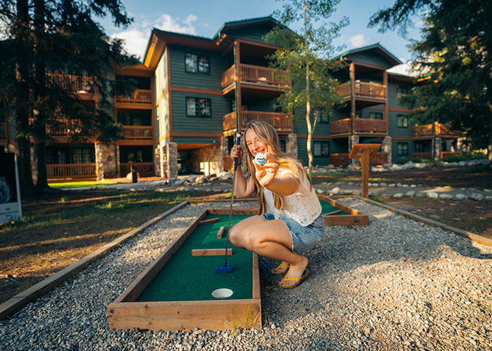 Hotel guest playing mini golf