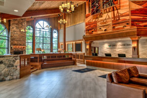 Reception area at Lake Louise Inn with sitting area in lobby, large windows bring in natural light