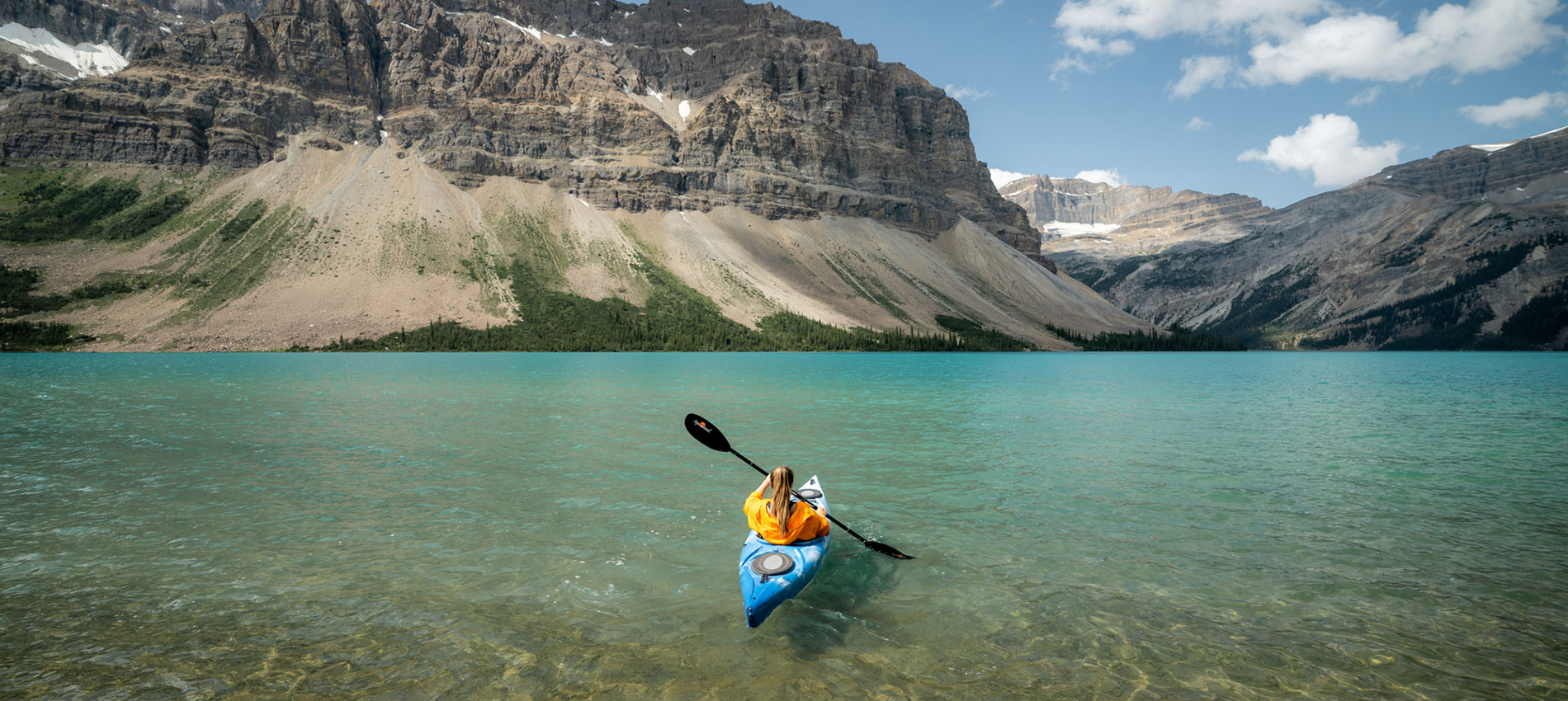 Kayaker on Lake Louise with mountains in the back